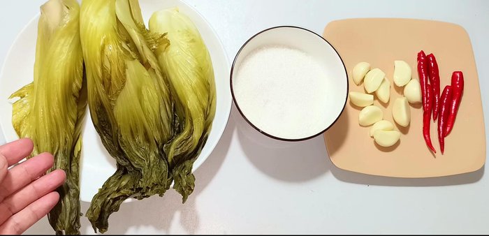 Prepare the pickled cabbage: Rinse the pickled cabbage twice with water, then squeeze out excess water to remove the sour taste. (You can find a link to a pickled cabbage recipe in the video description).