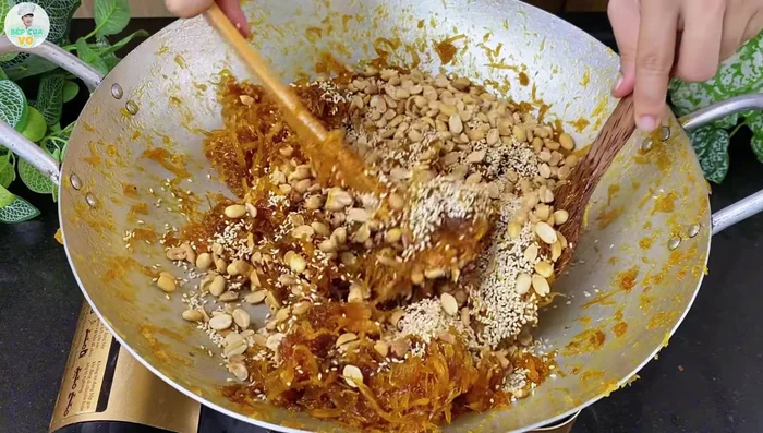 Add roasted peanuts and sesame seeds; stir until well combined.