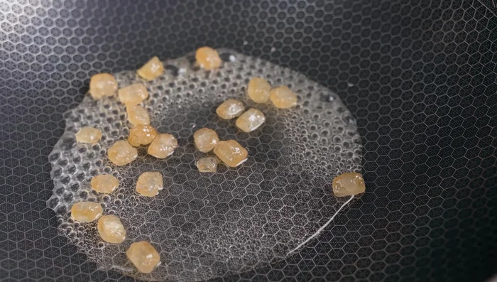 Caramelize rock sugar in a pan until light brown. Add water and other spices (seasoning powder, soy sauce, annatto powder/chili powder, salt, rock sugar).