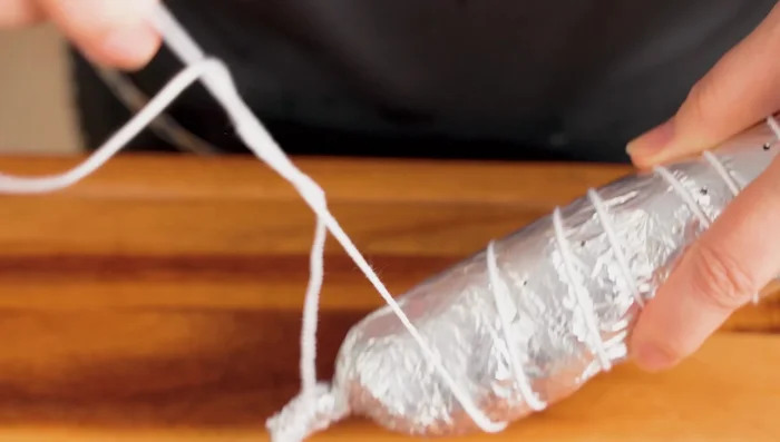 Secure the roll with string. Steam for 10 minutes to heat through and make it stickier. Freeze for an hour.