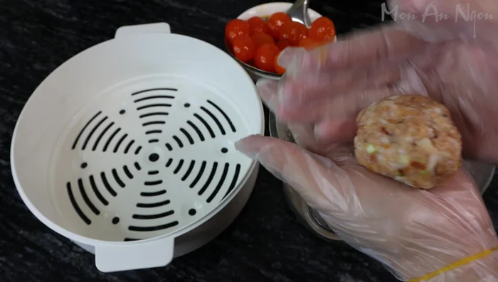 Shape the meatballs, pressing a salted egg yolk into the center of each.