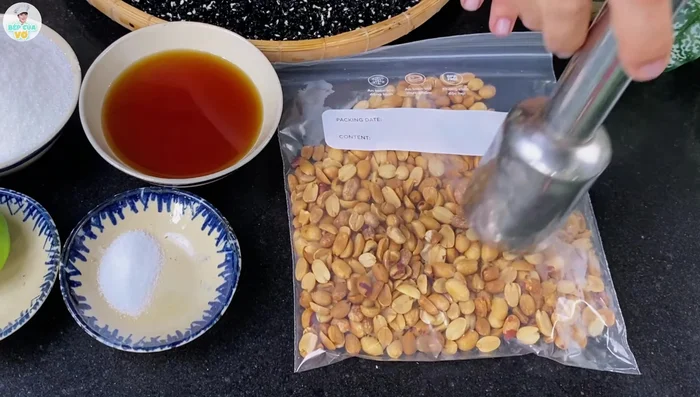Crush the roasted peanuts in a bag to a coarse consistency.