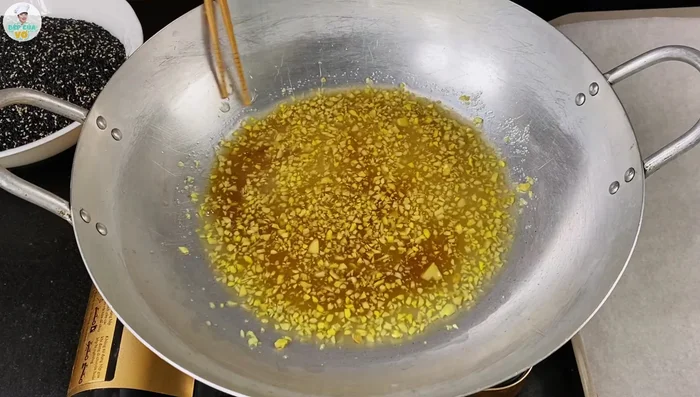 Add the blended ginger to the boiling sugar mixture. Continue to cook and stir, removing any foam that forms. The heat should remain at medium to medium-low.