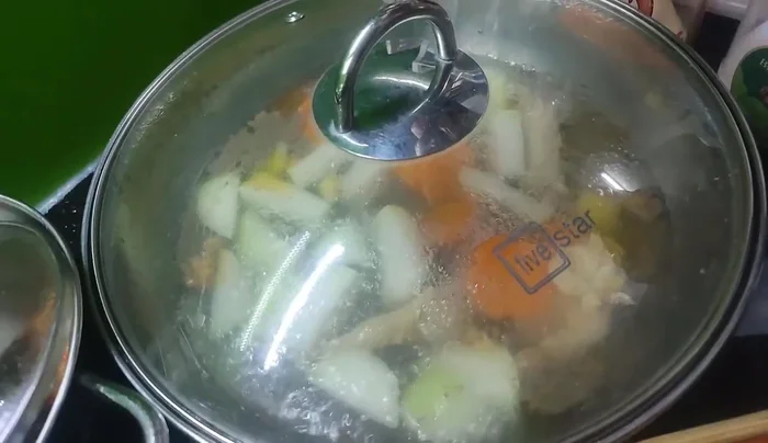 Slice the boiled chicken and arrange on a plate.