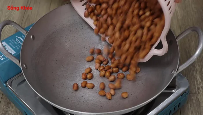 Immediately place washed peanuts into a pan over medium heat. Once hot, reduce heat to low-medium.