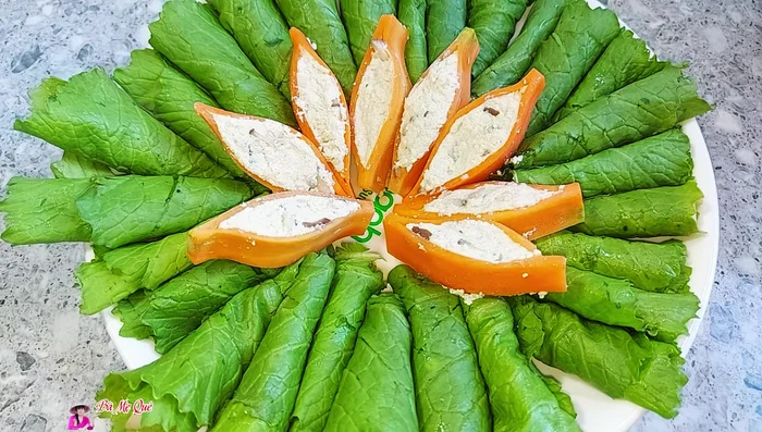 Arrange the green mustard rolls on a plate, top with the carrot petals. Steam for 4-5 minutes on medium heat.