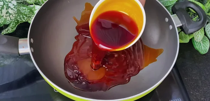 Put annatto oil into a pot on the stove.