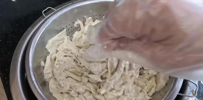 Add the drained tofu to the seasoning mixture, ensuring all pieces are coated. Let it marinate for 10-15 minutes.