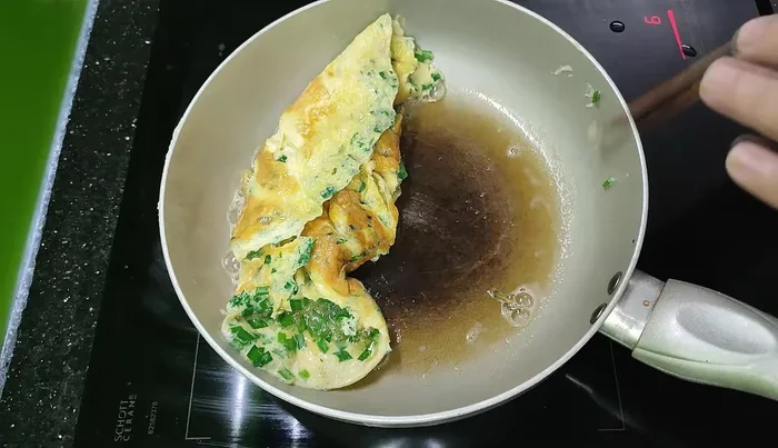 Flip the eggs and cook until golden brown.