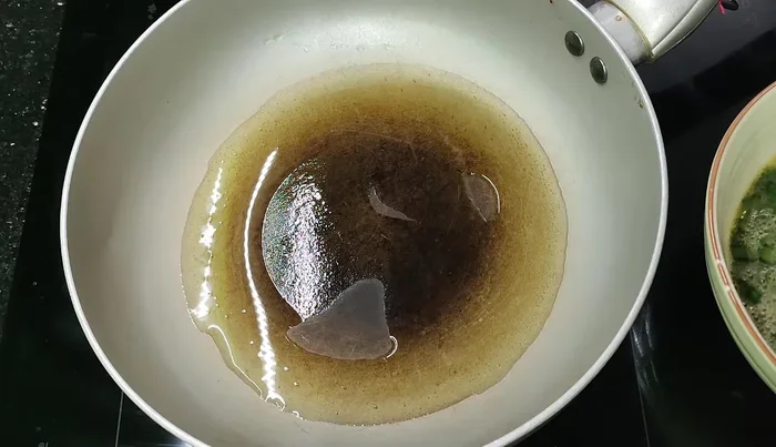 Heat cooking oil in a frying pan.