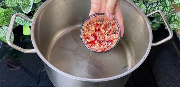 Blend onions, garlic, and chili peppers in a hand blender.