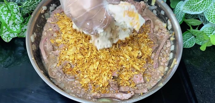 Incorporate remaining ingredients: Add fried garlic, fried onions, soaked bread, and eggs. Mix thoroughly. Add cheese (amount to taste).