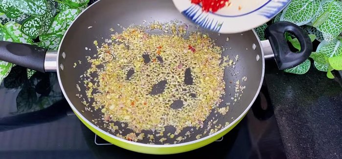 Add chili and pickled radish: Add the blended chili and stir-fry until fragrant. Add the prepared pickled radish and stir well to coat with the aromatics.