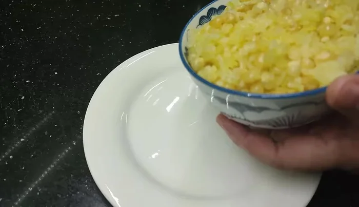 Serve the Lap Xuong Sticky Rice. Add desired toppings such as peanuts, sesame salt, green beans, shredded pork, and Phi nuts as preferred. [165.56]