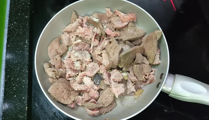 Add sesame seeds, oyster sauce, and continue stir-frying.