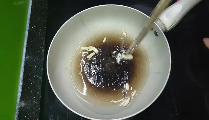 Add the stone sprout to the wok. Stir-fry.
