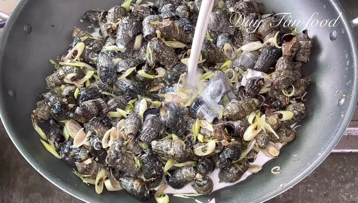 Reduce heat to low. Add coconut water (enough to almost cover the snails), sugar, seasoning powder, and salt. Stir to dissolve the spices.