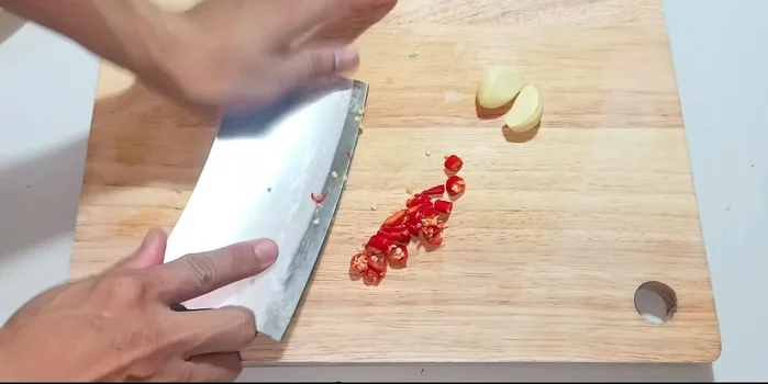 Prepare the aromatics: Mince the garlic and chili peppers. Juice the lemon and remove the seeds.