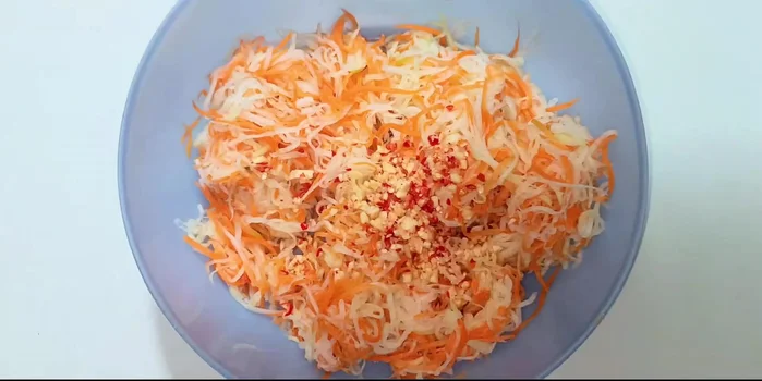 Combine: Add the minced garlic and chili, sugar, salt (a small amount as the vegetables were already marinated), and lemon juice. Mix well.