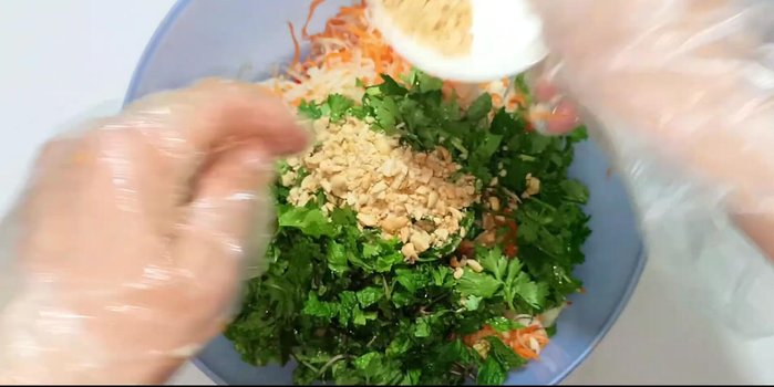 Add herbs and peanuts: Add the coriander, perilla, and most of the peanuts. Mix well. Sprinkle remaining peanuts on top.
