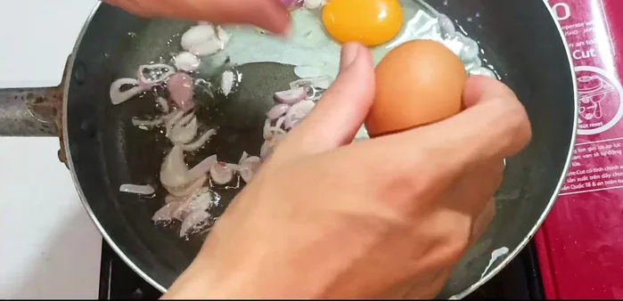 Crack eggs into the pan and cook until the egg whites are set but the yolks remain slightly runny.