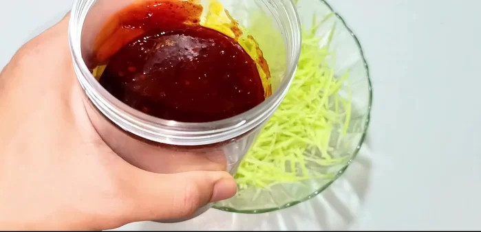 Prepare the sauce: Mix the pre-made Thai sauce with shredded mango. (Recipe link in video description).