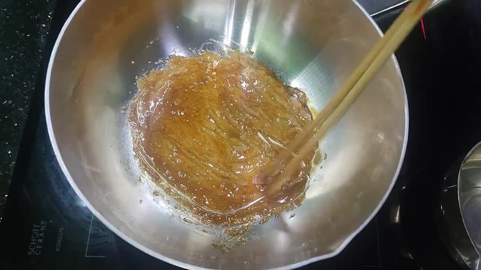 Make caramel by caramelizing sugar until golden brown. Add water carefully to prevent splattering.