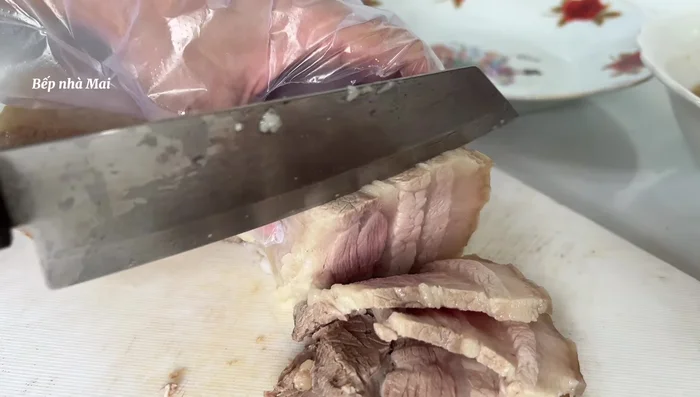 Serve the boiled pork with vermicelli, raw vegetables, and sweet and sour fish sauce. You can use rice paper to roll and dip or put everything in a bowl and pour the fish sauce on top.