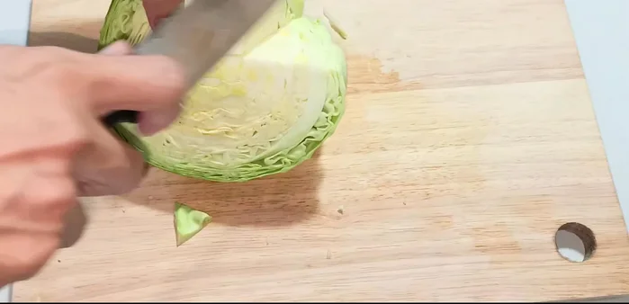 Cut off the hard stem from the cabbage and cut it into smaller pieces. Separate the layers and wash thoroughly.