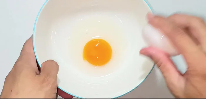 Crack the eggs into a bowl. Add MSG, pepper, and fish sauce. Whisk until well combined.