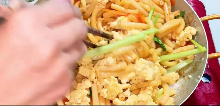 Add the stir-fried eggs and mix well. Add green onions and coriander. Stir-fry until everything is combined and heated through. Remove from heat.