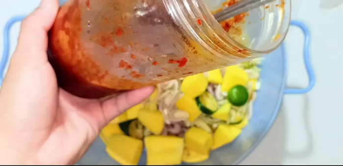 Mix with Thai Sauce: Add the prepared Thai sauce (recipe in video description) and mix well.