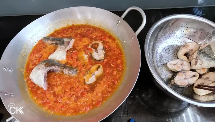 Add the fried fish to the tomato sauce mixture. Reduce heat to low and simmer for about 30 minutes, allowing the fish to absorb the flavors. (337.16)