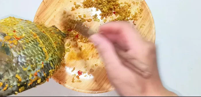 Remove excess lemongrass from the fish, leaving the lemongrass inside the fish.