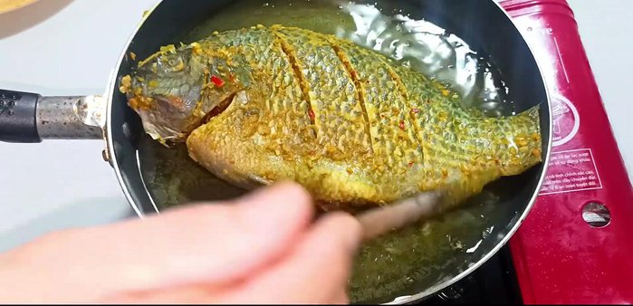 Fry the fish gently over medium-low heat until golden and crispy on both sides, flipping occasionally.