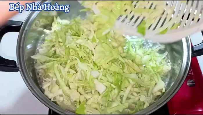 Add the prepared cabbage to the boiling water, stir well, and cover to cook.