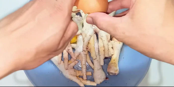 Prepare egg mixture: Beat an egg, removing the white part. Mix well with the chicken feet to help flour adhere.