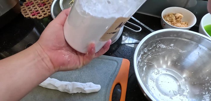 Roll the dough into small balls, coating them in tapioca starch to prevent sticking.