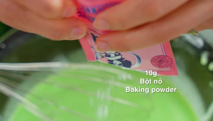 Add baking powder to the batter and sieve the mixture to ensure a smooth consistency.