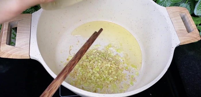 Sauté aromatics: Heat cooking oil in a pot. Add lemongrass and stir-fry until fragrant and golden brown. Add the blended garlic, chili, and ginger mixture; stir-fry until fragrant.