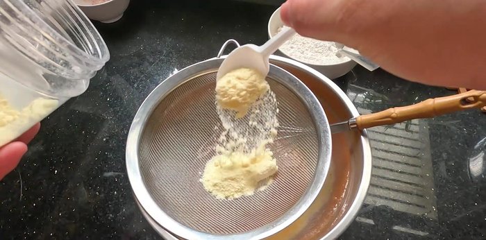 Sift in milk powder and flour. Add about 30ml of water and mix until smooth.