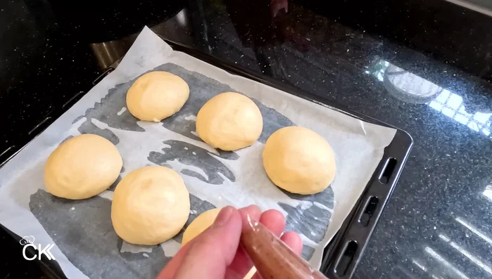 Assemble and bake: Place the dough balls onto a baking sheet. Pipe the cocoa topping onto each dough ball (410.52).