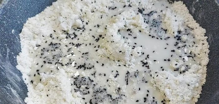 Gradually add 100ml of water, stirring continuously to prevent lumps. Continue mixing for about 5 minutes until the dough is smooth and soft.