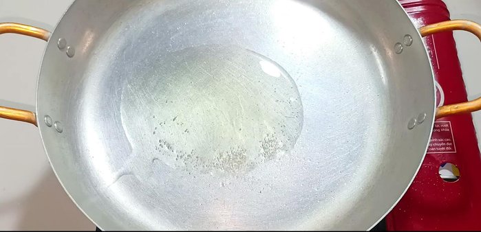 Heat oil in a pan over medium heat. Fry half the garlic until golden brown.