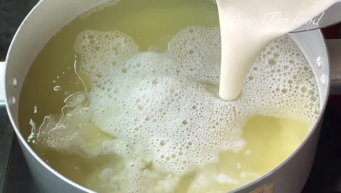 Combine and simmer: Return the blended mixture to the pot with the remaining cooking liquid. Add remaining fresh milk, rock sugar, condensed milk, salt, and pandan leaves. Simmer over low heat until hot, stirring regularly.