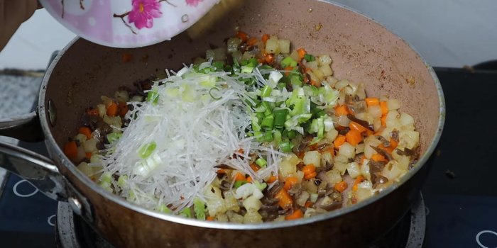 Add mushrooms, green onions, and cooked quail eggs. Stir in the minced meat, which has been marinated with sugar, seasoning powder, oyster sauce, and fried onions.