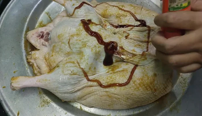 Cut open the duck and peel off the skin on the inside, then marinate the inside similarly to the outside.