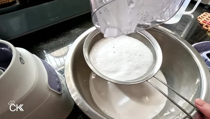 Strain the rice batter through a sieve to remove any lumps.