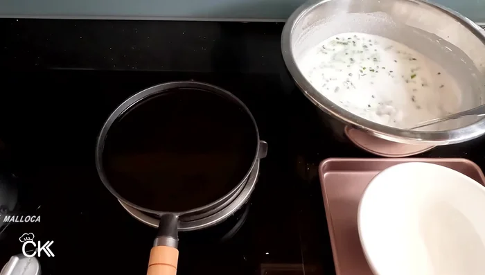 Pour a ladle of batter into the hot pan, swirling to create a thin crepe.