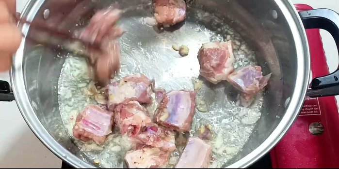 Add the marinated ribs to the pot and stir well until browned slightly.